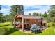 Exterior elevation of home from the backyard with a raised deck and manicured lawn at 8662 Kim Ct, Parker, CO 80134
