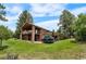 Rear exterior of the home from a full-lawn perspective, with stairs leading to a deck at 8662 Kim Ct, Parker, CO 80134