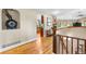 Bright hallway featuring hardwood floors, arched doorways, and stylish decor, creating an inviting transition space at 8662 Kim Ct, Parker, CO 80134
