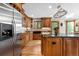 Gourmet kitchen featuring stainless steel appliances, custom cabinets, a center island, and abundant natural light at 8662 Kim Ct, Parker, CO 80134