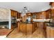 Spacious kitchen featuring custom cabinets, an island with black countertops, stainless steel appliances, and hardwood floors at 8662 Kim Ct, Parker, CO 80134