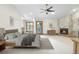 Serene main bedroom with a stone fireplace, neutral tones, and large windows, creating a peaceful retreat at 8662 Kim Ct, Parker, CO 80134