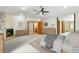 Serene main bedroom boasts a stone fireplace, neutral tones, and ensuite access, offering a tranquil retreat at 8662 Kim Ct, Parker, CO 80134