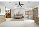 Spacious main bedroom featuring neutral colors, a ceiling fan, and large windows, with an en-suite bathroom at 8662 Kim Ct, Parker, CO 80134