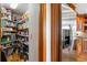 Well-organized walk-in pantry with ample shelving for storage, adjacent to a stainless steel refrigerator in the kitchen at 8662 Kim Ct, Parker, CO 80134