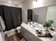 Well-lit bathroom with a gray vanity, neutral wall, a large mirror, and stylish decor at 3074 Distant Rock Ave, Castle Rock, CO 80109