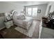 Serene bedroom with queen bed, window seat, and soft color palette at 3074 Distant Rock Ave, Castle Rock, CO 80109