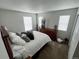 Comfortable bedroom with a full bed, dresser and neutral decor at 3074 Distant Rock Ave, Castle Rock, CO 80109