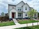 Two-story farmhouse-style home with a red door and landscaped lawn at 3074 Distant Rock Ave, Castle Rock, CO 80109