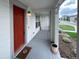 Inviting front porch with a red door and a view of the street at 3074 Distant Rock Ave, Castle Rock, CO 80109