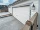 Garage featuring white door, siding, with the house number visible on the side at 3074 Distant Rock Ave, Castle Rock, CO 80109