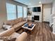 Cozy living room features a fireplace, plush seating, and plentiful natural light from the windows at 3074 Distant Rock Ave, Castle Rock, CO 80109