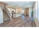 Open concept living space with modern flooring, staircase, and plentiful natural light at 3074 Distant Rock Ave, Castle Rock, CO 80109