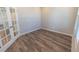 Empty office features stylish wood floors, white trim, and a glass paneled door for optimal natural lighting at 3074 Distant Rock Ave, Castle Rock, CO 80109