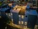 Aerial view of the townhomes at dusk with rooftop string lights, creating a cozy and inviting atmosphere at 2922 W 26Th Ave # 4, Denver, CO 80211