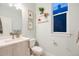 Well-lit bathroom with a white vanity, modern fixtures, decorative wall art, and a window at 2922 W 26Th Ave # 4, Denver, CO 80211