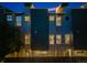 Modern home exterior at twilight, showcasing multiple windows and a fenced yard at 2922 W 26Th Ave # 4, Denver, CO 80211