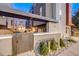 Contemporary building exterior with a gated entrance and landscaped garden beds, blending style and security at 2922 W 26Th Ave # 4, Denver, CO 80211