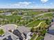 Expansive aerial view featuring a well-maintained home, scenic pond, green spaces, and cul-de-sac in a charming neighborhood at 3554 E 143Rd Pl, Thornton, CO 80602