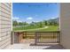 Beautiful backyard view from back deck, showcasing a scenic green space with a walking path and white fence at 3554 E 143Rd Pl, Thornton, CO 80602