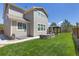 Spacious backyard featuring well-maintained lawn, custom stone fire pit and gazebo at 3554 E 143Rd Pl, Thornton, CO 80602