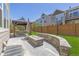Well-manicured backyard featuring a custom stone fire pit and gazebo at 3554 E 143Rd Pl, Thornton, CO 80602