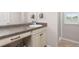 Bathroom vanity features neutral countertops, and cabinetry with dark hardware, adjacent to walk in shower at 3554 E 143Rd Pl, Thornton, CO 80602