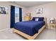 Comfortable bedroom with natural light, blue accents, and equestrian themed decorations at 3554 E 143Rd Pl, Thornton, CO 80602