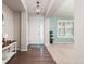 Inviting entryway boasts hardwood floors, a stylish light fixture, and a view into the adjacent living area at 3554 E 143Rd Pl, Thornton, CO 80602
