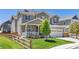 Charming two-story home with well-maintained lawn and inviting front porch at 3554 E 143Rd Pl, Thornton, CO 80602