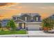 Beautiful two-story home featuring a manicured lawn, stone accents, and a spacious two car garage at 3554 E 143Rd Pl, Thornton, CO 80602
