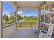 Charming front porch with rocking chairs and picturesque views of a grassy field at 3554 E 143Rd Pl, Thornton, CO 80602