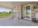 Charming front porch with stone accents, rocking chairs, and a view of green spaces at 3554 E 143Rd Pl, Thornton, CO 80602