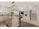 Open kitchen layout with granite island, stainless appliances, and seamless flow to living area at 3554 E 143Rd Pl, Thornton, CO 80602