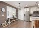 Updated kitchen with modern stainless-steel appliances, stylish lighting, and beautiful wood-look accent wall at 3554 E 143Rd Pl, Thornton, CO 80602