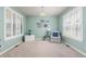 Bright living room with soft, mint-green walls, shuttered windows, and neutral carpet for a serene atmosphere at 3554 E 143Rd Pl, Thornton, CO 80602