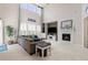 Cozy living room featuring fireplace, high ceilings, large windows and plush sectional sofa at 3554 E 143Rd Pl, Thornton, CO 80602