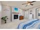 Relaxing bedroom featuring a fireplace, ceiling fan and a neutral color scheme at 3554 E 143Rd Pl, Thornton, CO 80602