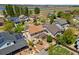 An aerial view of a landscaped home featuring mature trees and a patio at 11370 Iola St, Commerce City, CO 80640