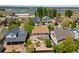 Aerial view shows a landscaped home in a neighborhood close to a lake at 11370 Iola St, Commerce City, CO 80640