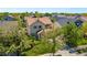 An elevated suburban home showcasing the beautiful green landscaping and nearby houses at 11370 Iola St, Commerce City, CO 80640