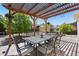 Backyard patio featuring an outdoor dining set under a wooden pergola with string lights at 11370 Iola St, Commerce City, CO 80640
