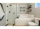 Stylish bathroom featuring a tub, glass enclosed shower, and modern fixtures at 11370 Iola St, Commerce City, CO 80640