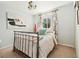 Bright bedroom with metal bed frame, pastel bedding, and ample natural light at 11370 Iola St, Commerce City, CO 80640