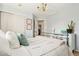 Light filled bedroom featuring a decorative chandelier, closet, and calming neutral paint at 11370 Iola St, Commerce City, CO 80640