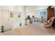 Bright bonus room featuring an ornate chair, 3 windows and built in desk space at 11370 Iola St, Commerce City, CO 80640