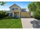 Charming two-story home with a well-maintained lawn and inviting front porch at 11370 Iola St, Commerce City, CO 80640