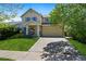 Charming two-story home with a manicured lawn, inviting entrance, and attached two car garage at 11370 Iola St, Commerce City, CO 80640