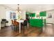 Bright kitchen featuring unique green cabinets and an open floor plan at 11370 Iola St, Commerce City, CO 80640