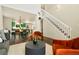 Bright living room featuring two-story ceilings, stylish seating, and an open floor plan at 11370 Iola St, Commerce City, CO 80640